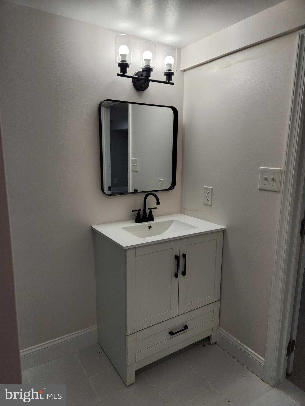 502 East Schuyler Road Silver Spring, MD 20901 - Photo 22 of 38 a bathroom with a sink and a mirror