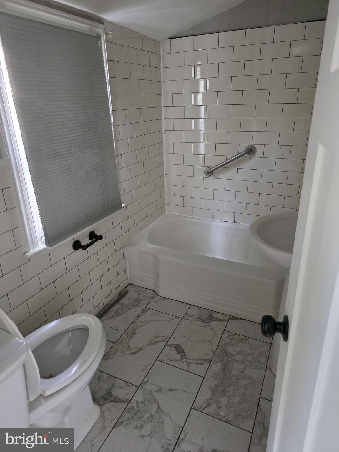 502 East Schuyler Road Silver Spring, MD 20901 - Photo 34 of 38 a bathroom with a bathtub and shower