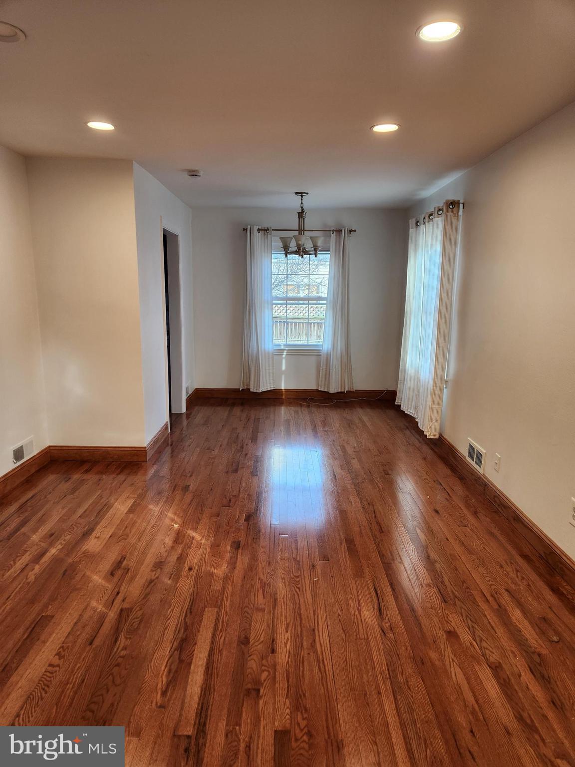 502 East Schuyler Road Silver Spring, MD 20901 - Photo 5 of 38 an empty room with wooden floor and windows