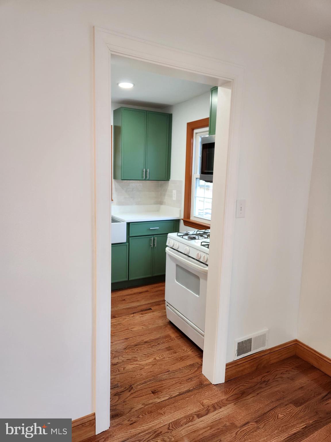 502 East Schuyler Road Silver Spring, MD 20901 - Photo 7 of 38 a kitchen with sink cabinets and stove