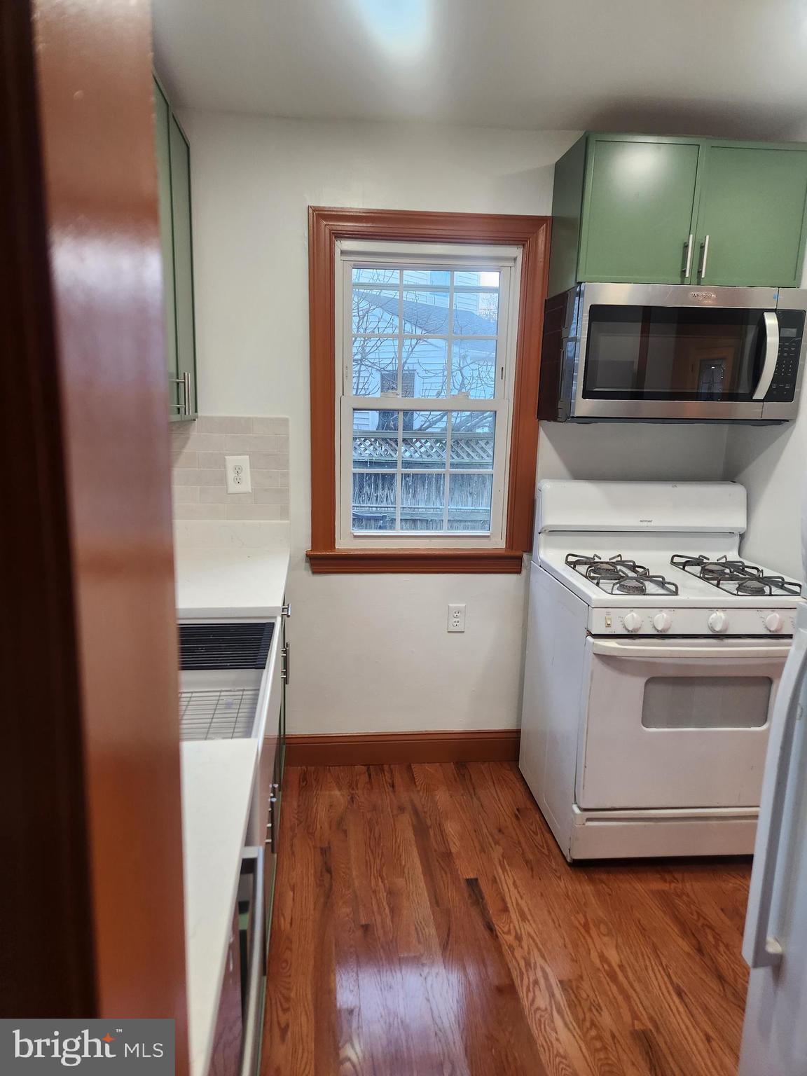 502 East Schuyler Road Silver Spring, MD 20901 - Photo 10 of 38 a kitchen with a wooden floor and a stove top oven