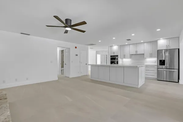 a view of a kitchen with a sink and stainless steel appliances