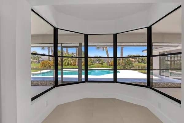 a view of empty room with large windows