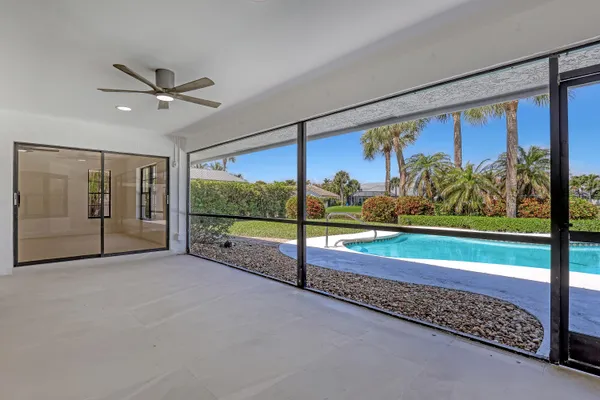 a view of a porch with a floor to ceiling window next to a yard
