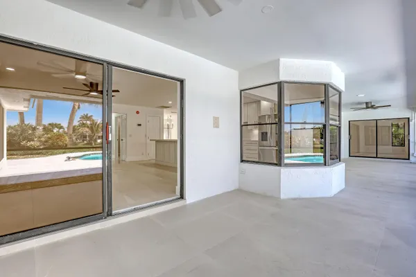 a view of an empty room with a floor to ceiling window and an outdoor view