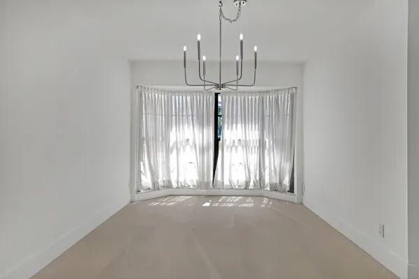 a bathroom with a sink mirror vanity and toilet