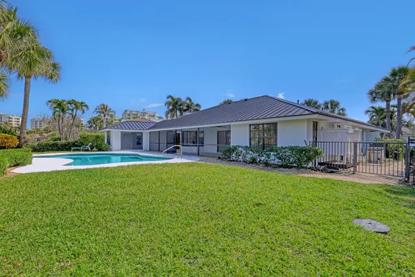 a front view of a house with a garden and yard