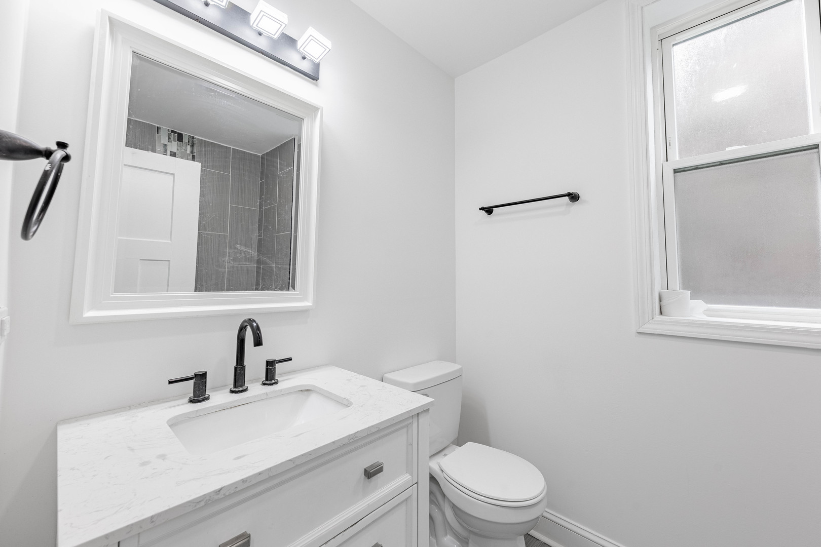 4453 West Adams Street Chicago, IL 60624 - Photo 11 of 32 a bathroom with a granite countertop sink toilet a mirror and shower