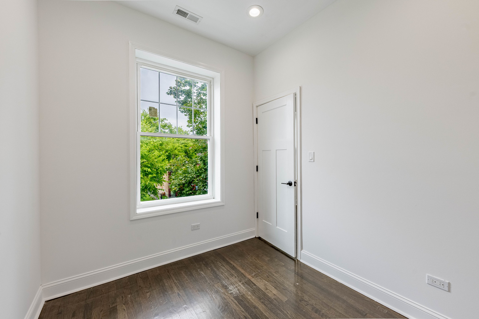 4453 West Adams Street Chicago, IL 60624 - Photo 13 of 32 an empty room with wooden floor and windows