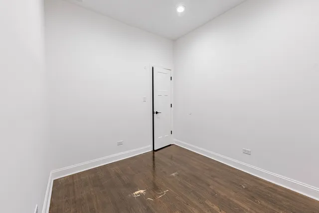 an empty room with wooden floor