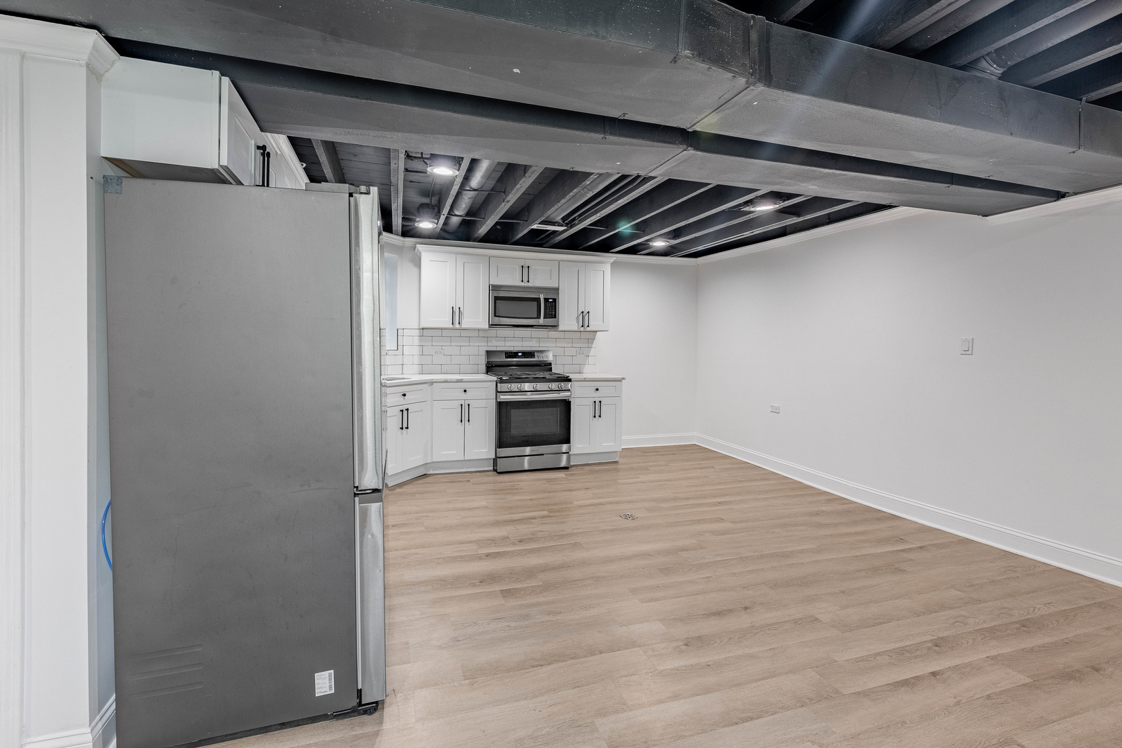 4453 West Adams Street Chicago, IL 60624 - Photo 21 of 32 a view of a refrigerator in kitchen and an empty room