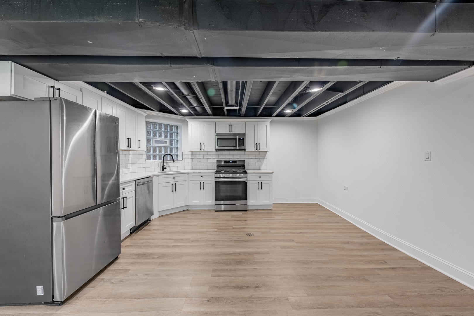 4453 West Adams Street Chicago, IL 60624 - Photo 22 of 32 a view of kitchen with refrigerator and wooden floor