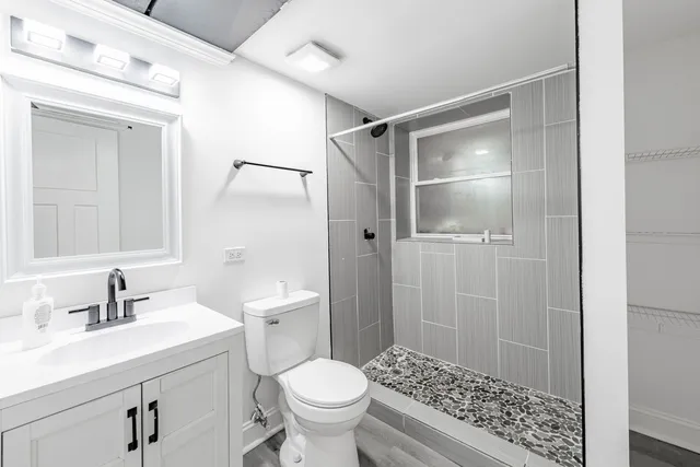 a bathroom with a sink toilet and shower