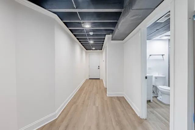 a view of hallway with wooden floor