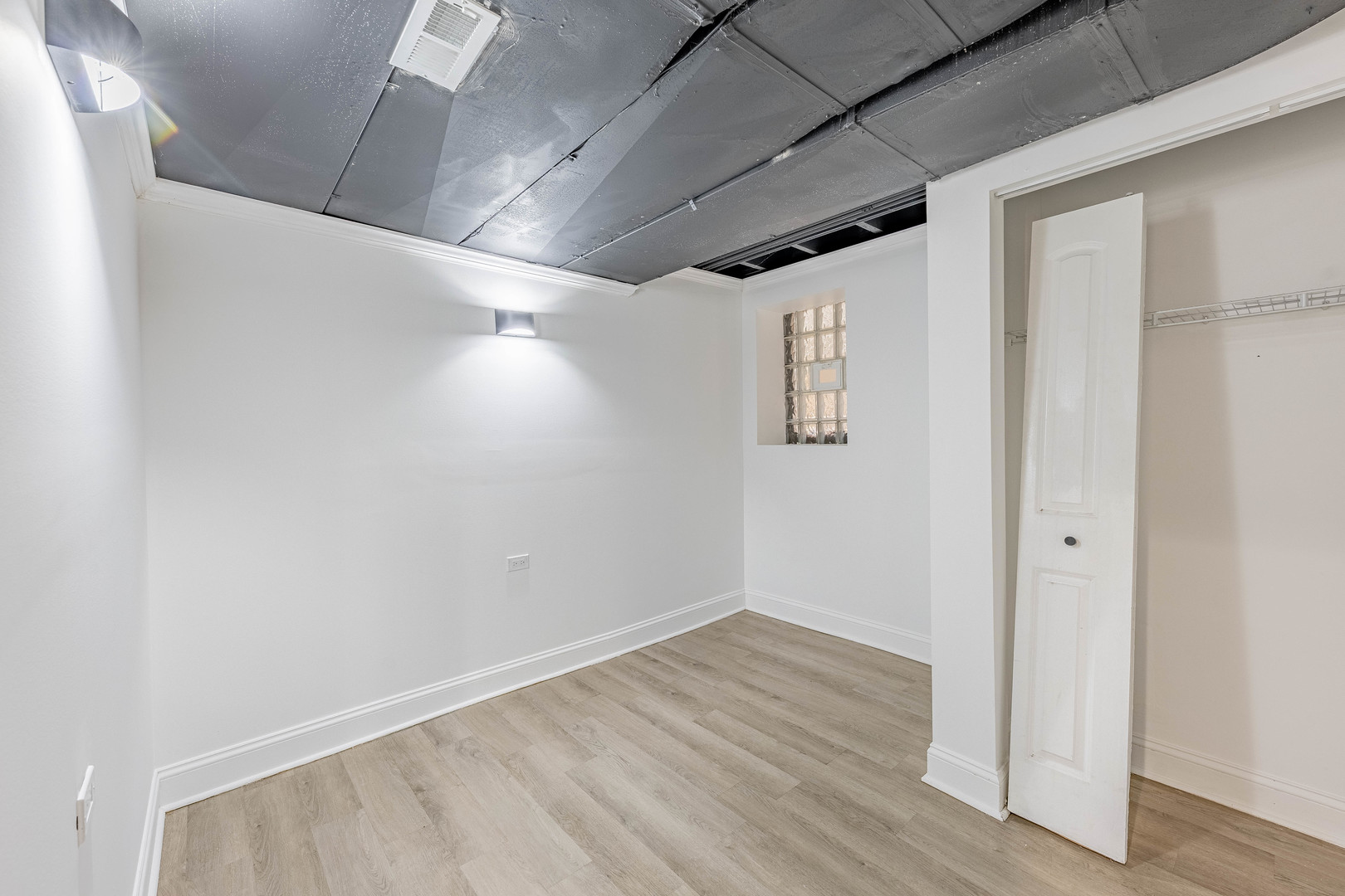 4453 West Adams Street Chicago, IL 60624 - Photo 28 of 32 an empty room with wooden floor and windows