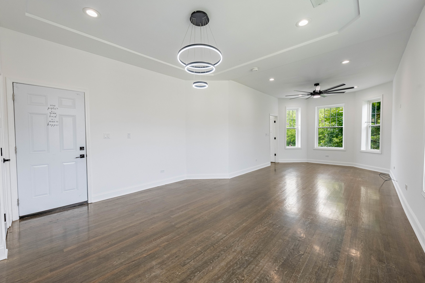 4453 West Adams Street Chicago, IL 60624 - Photo 3 of 32 an empty room with wooden floor and windows
