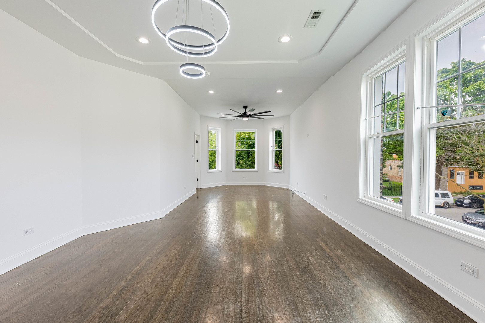4453 West Adams Street Chicago, IL 60624 - Photo 4 of 32 an empty room with wooden floor and windows
