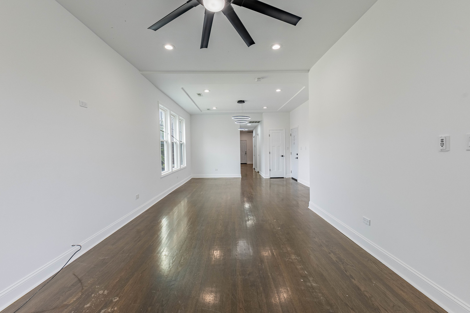 4453 West Adams Street Chicago, IL 60624 - Photo 5 of 32 an empty room with wooden floor and windows