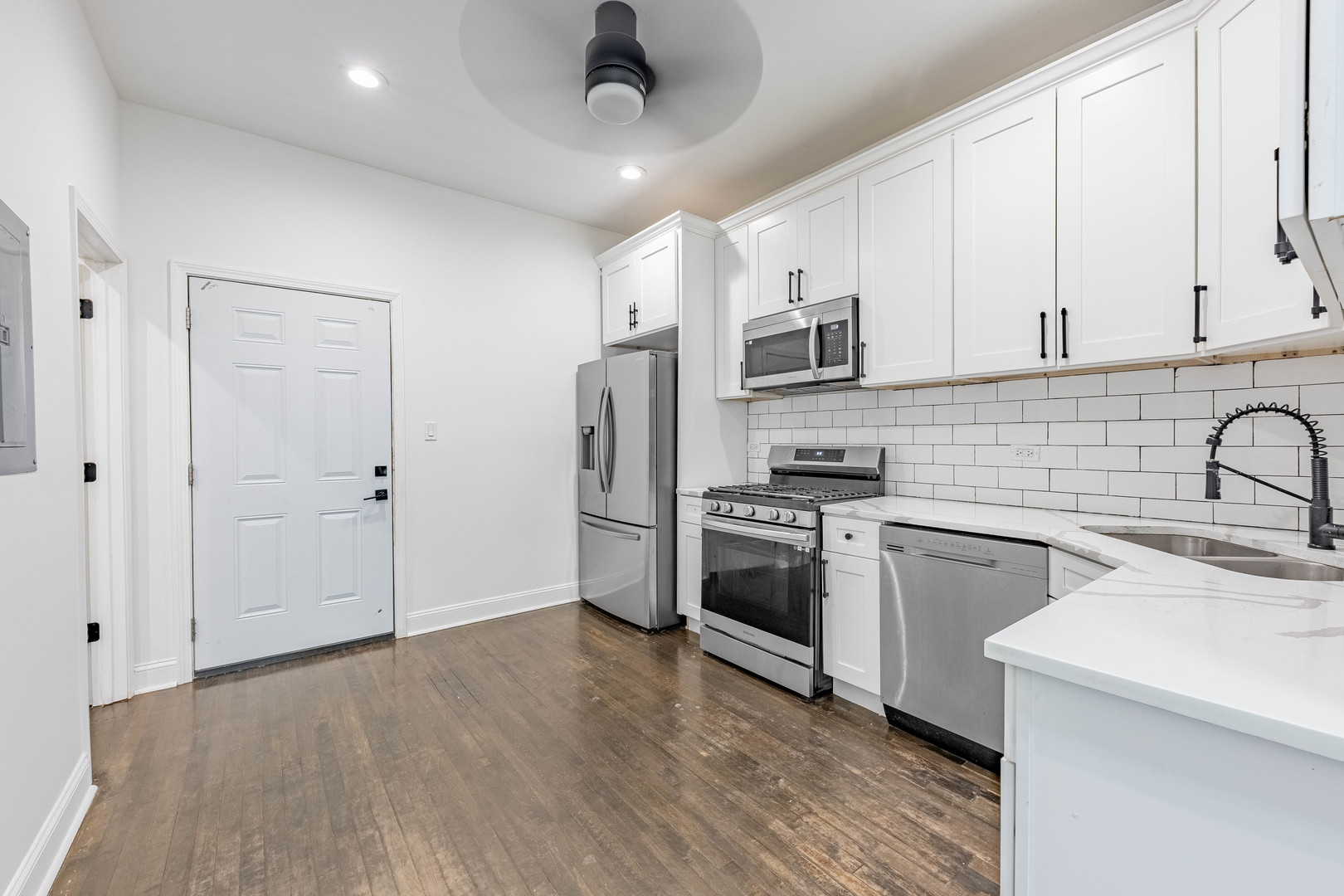 4453 West Adams Street Chicago, IL 60624 - Photo 8 of 32 a kitchen with stainless steel appliances a refrigerator sink and microwave