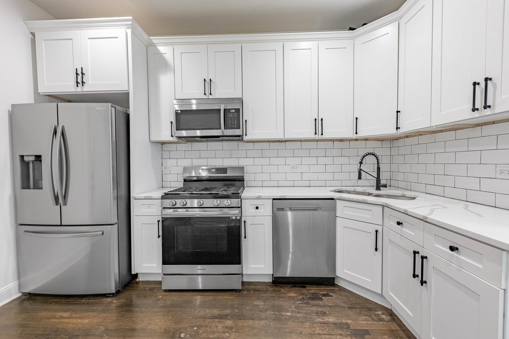 4453 West Adams Street Chicago, IL 60624 - Photo 9 of 32 a kitchen with stainless steel appliances granite countertop a refrigerator sink and stove