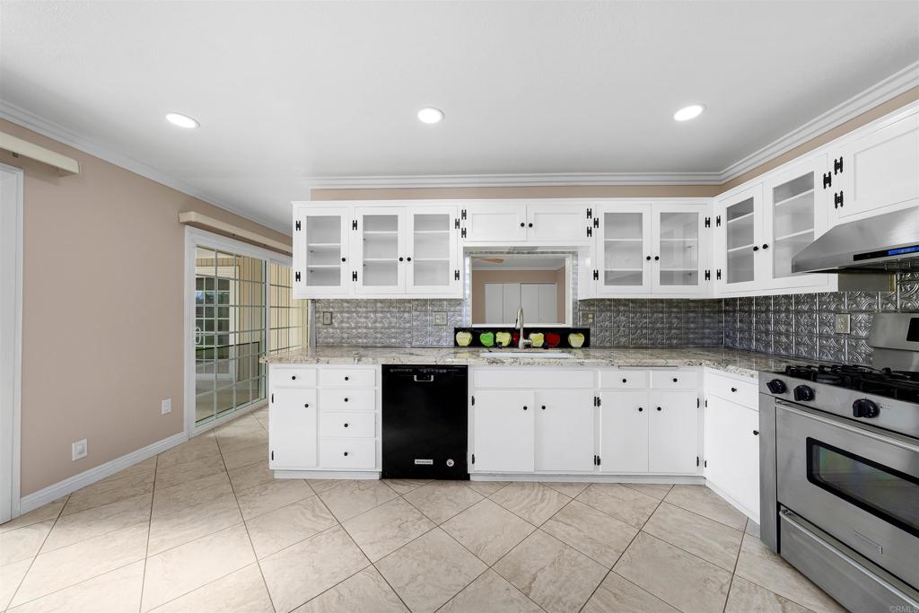2073 Valley Rim Road El Cajon, CA 92019 - Photo 11 of 33 a kitchen with granite countertop a stove top oven and cabinets