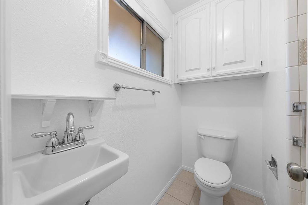 2073 Valley Rim Road El Cajon, CA 92019 - Photo 19 of 33 a bathroom with a sink a toilet and vanity