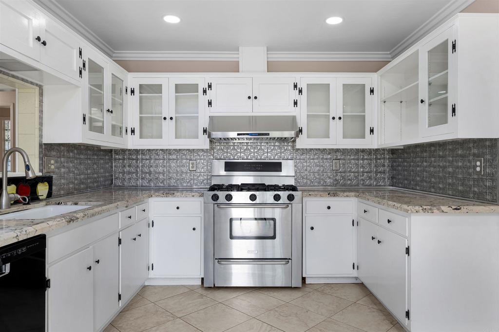 2073 Valley Rim Road El Cajon, CA 92019 - Photo 9 of 33 a kitchen with granite countertop a stove sink and cabinets
