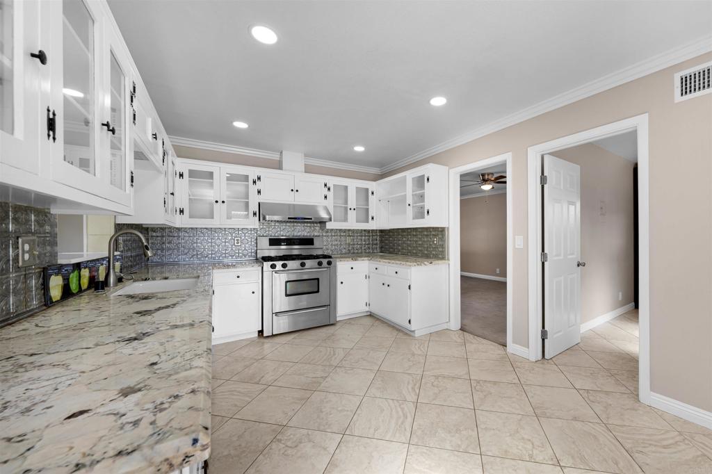 2073 Valley Rim Road El Cajon, CA 92019 - Photo 10 of 33 a large kitchen with stainless steel appliances and cabinets