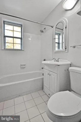 a bathroom with a sink a toilet and a bathtub