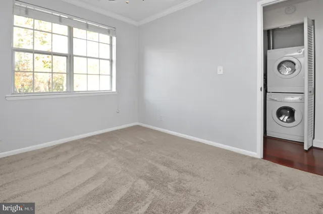 an empty room with windows and mirror