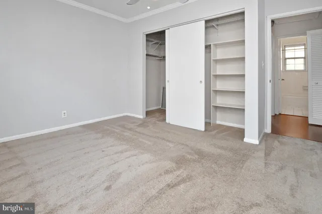 a view of an empty room with a closet