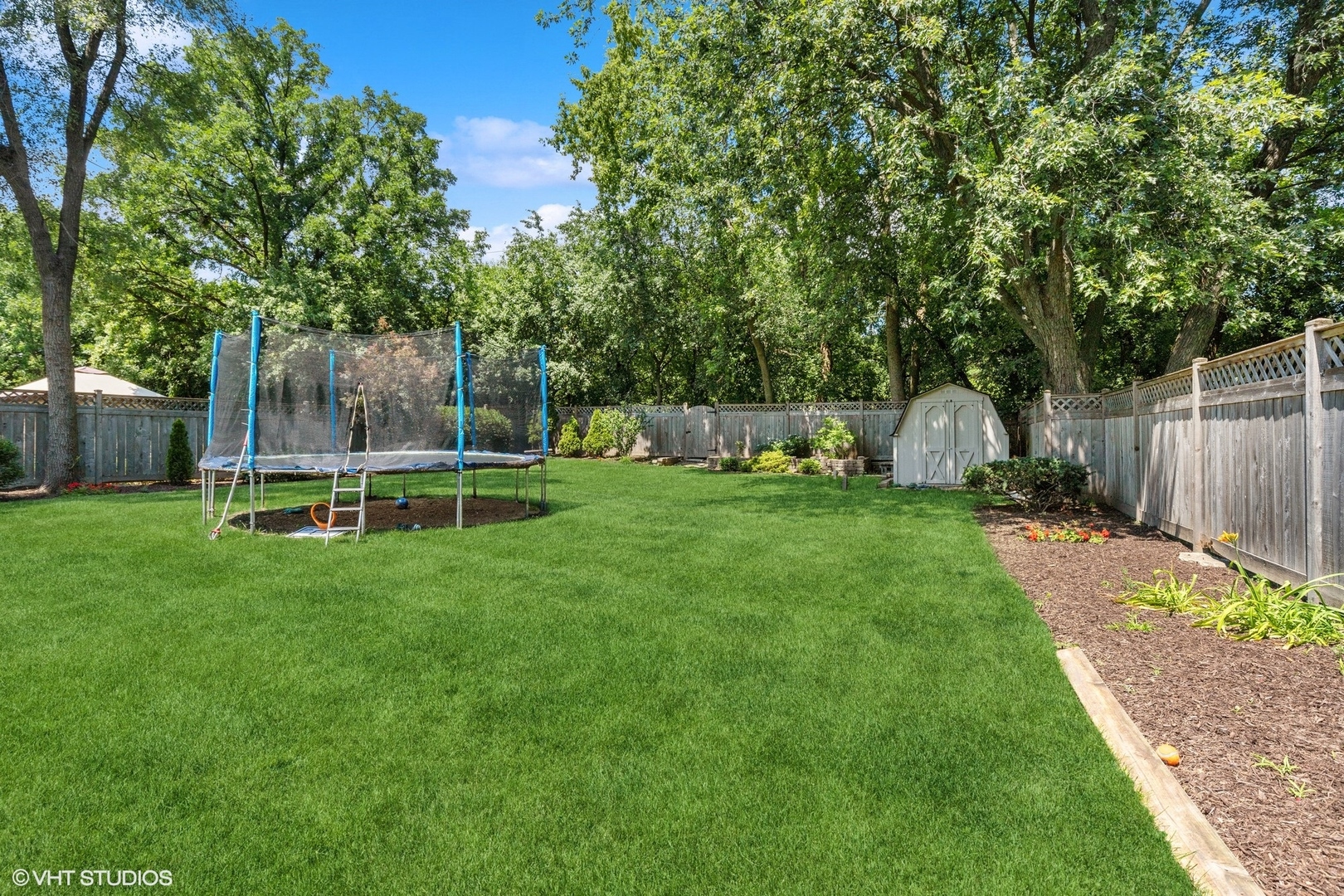 1005 Jenkisson Avenue Lake Bluff, IL 60044 - Photo 16 of 16 a view of a house with backyard and a slide