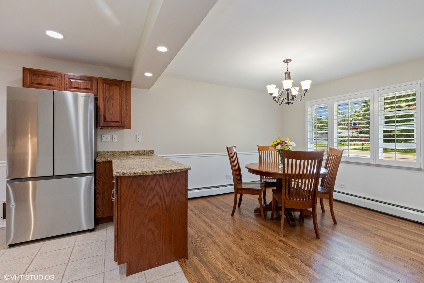 1005 Jenkisson Avenue Lake Bluff, IL 60044 - Photo 5 of 16 a dining room with furniture a chandelier and wooden floor