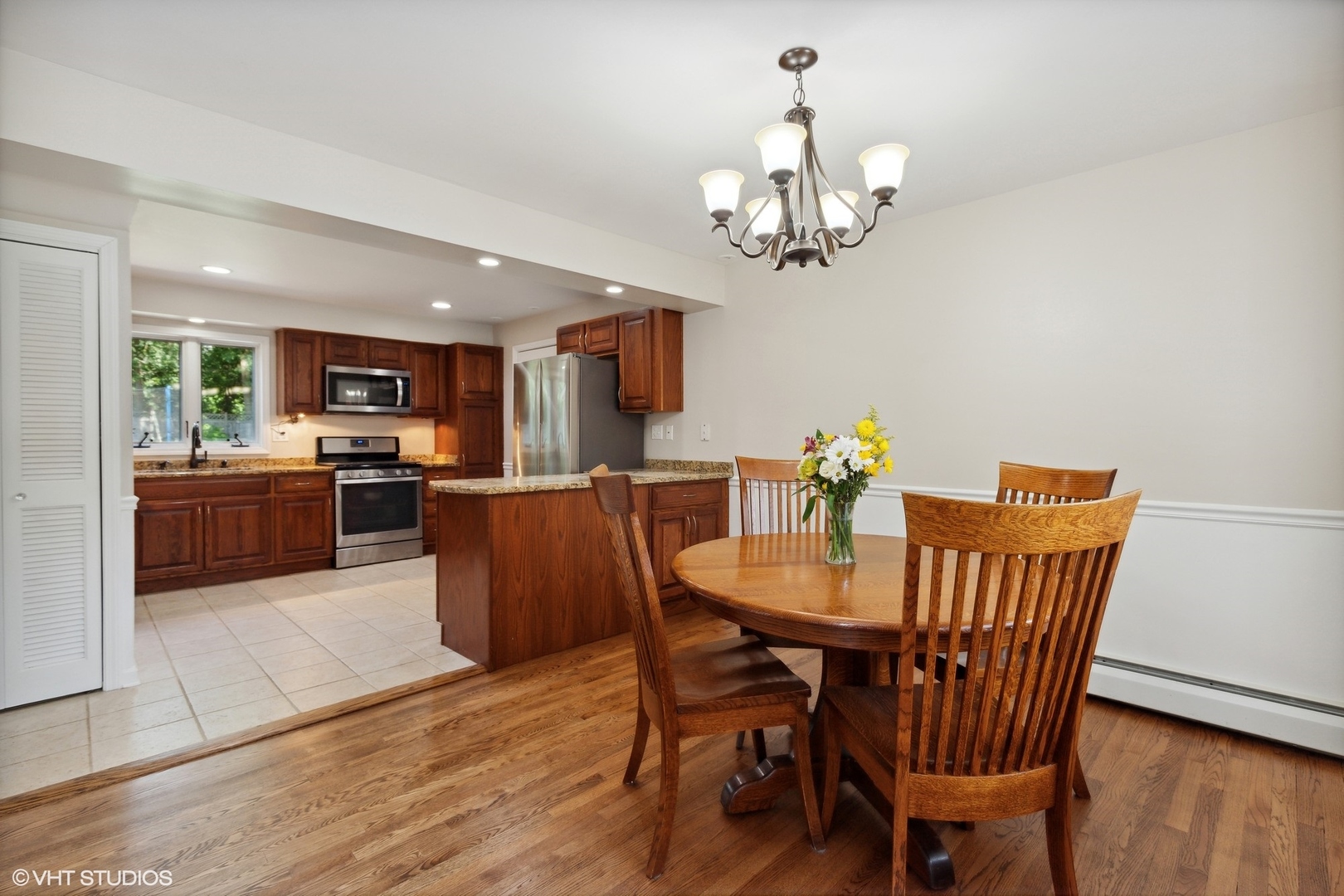 1005 Jenkisson Avenue Lake Bluff, IL 60044 - Photo 6 of 16 a view of a dining room with furniture wooden floor and chandelier