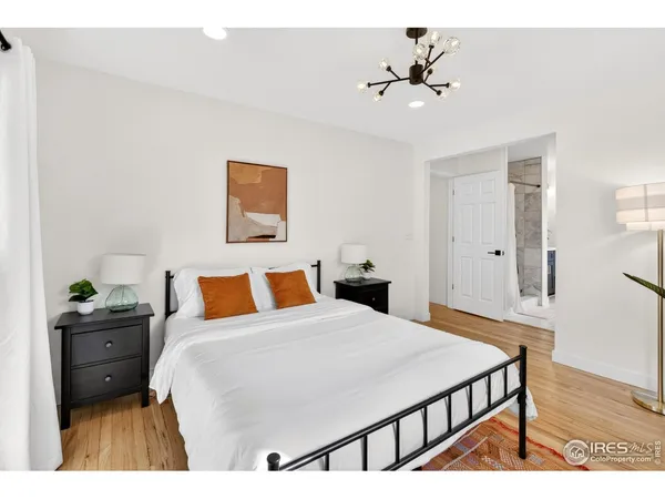 a bedroom with a bed and a chandelier