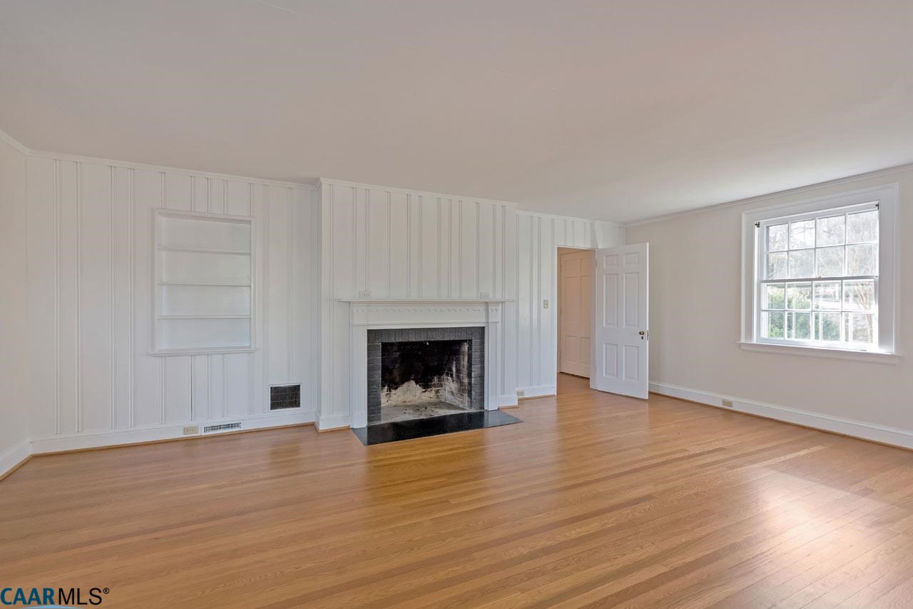 1536 Dairy Road Charlottesville, VA 22903 - Photo 15 of 37 Living room with wood burning fireplace opens to the sunroom and rear covered porch.