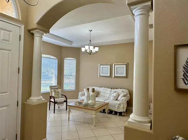 a spacious bedroom with a bed and a chandelier