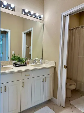 a bathroom with a double vanity sink and a mirror