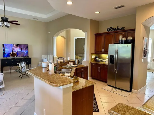 a kitchen with refrigerator and furniture