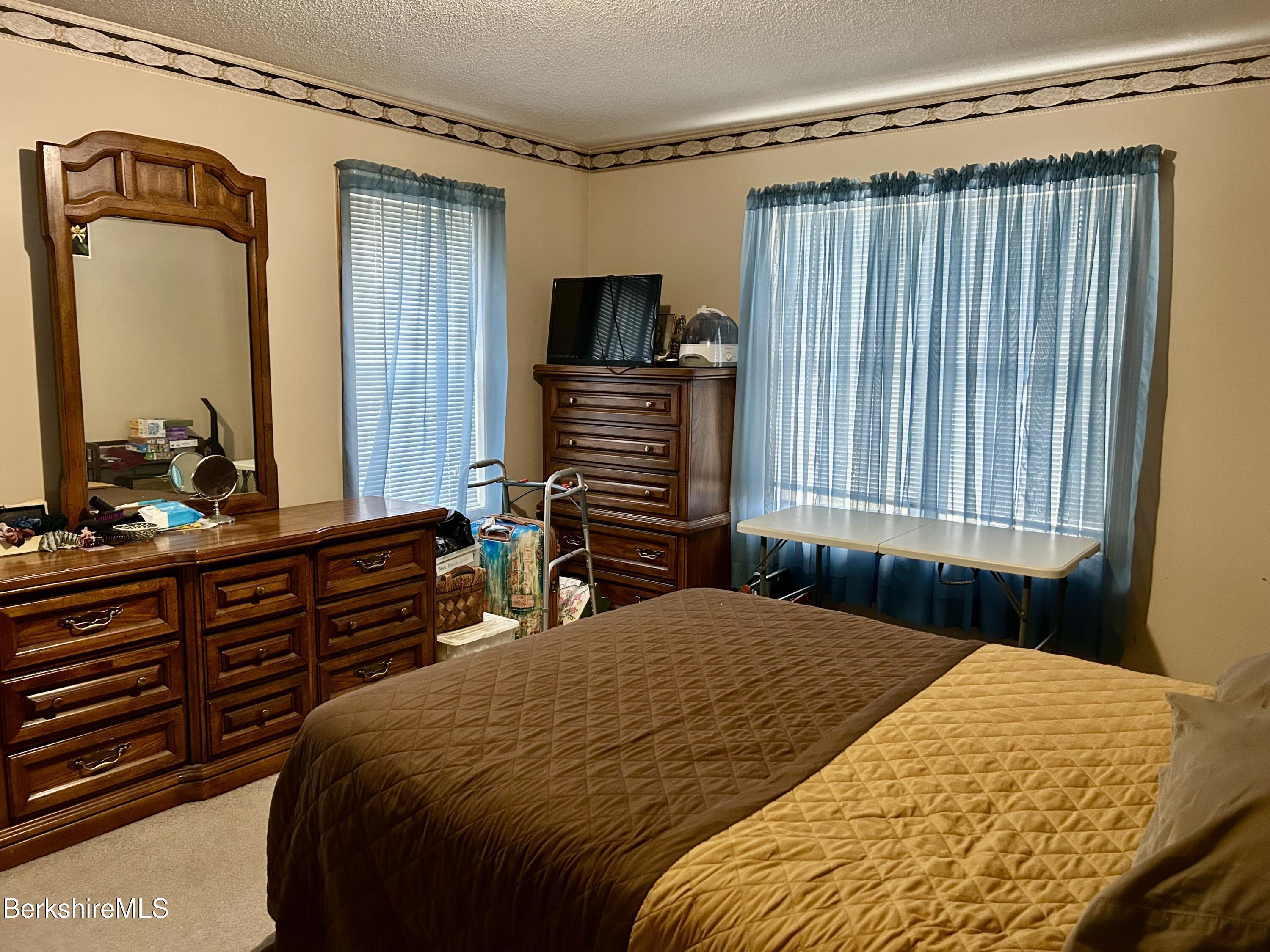 20 Richmond Way Chicopee, MA 01022 - Photo 10 of 25 a bedroom with a bed and a dresser