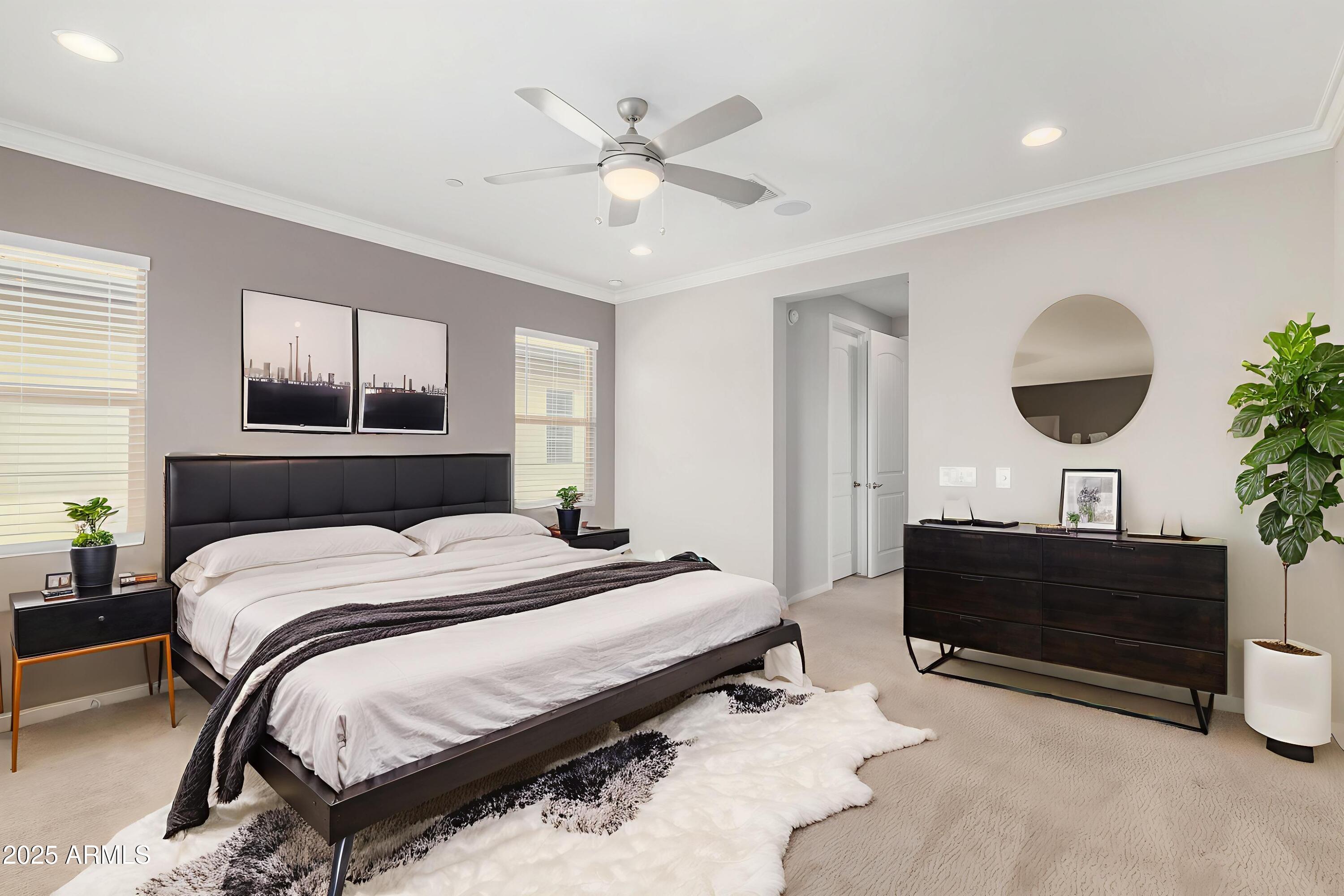 1848 South Follett Way Gilbert, AZ 85295 - Photo 11 of 32 a spacious bedroom with a bed and a chandelier