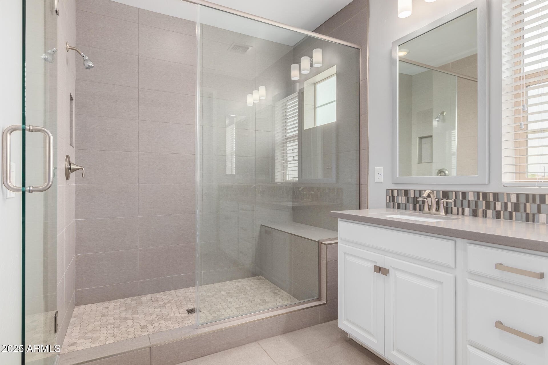 1848 South Follett Way Gilbert, AZ 85295 - Photo 13 of 32 a bathroom with a granite countertop sink a mirror and a shower
