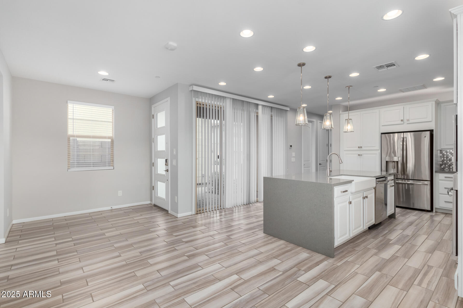 1848 South Follett Way Gilbert, AZ 85295 - Photo 25 of 32 a large kitchen with a lot of white cabinets stainless steel appliances