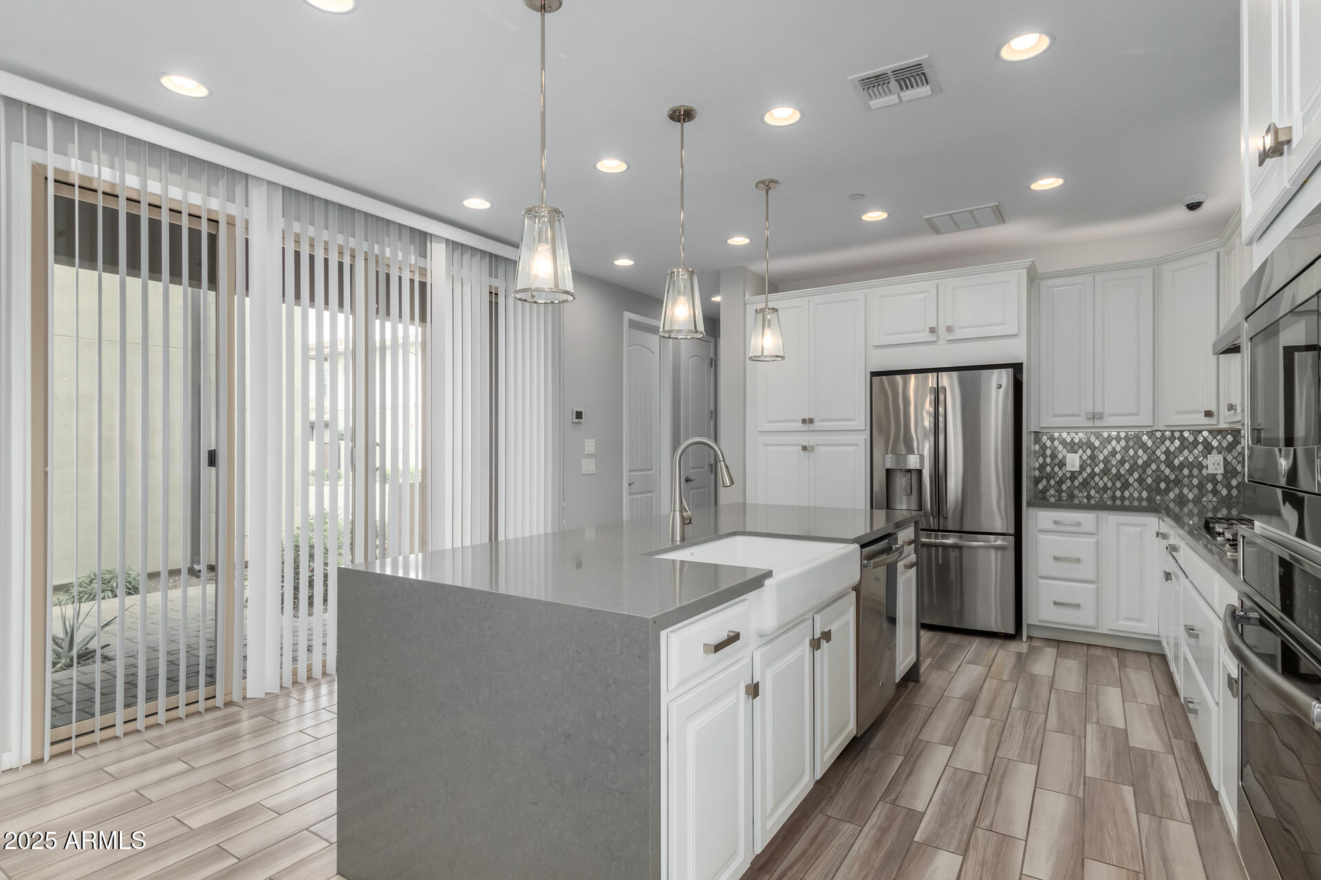 1848 South Follett Way Gilbert, AZ 85295 - Photo 9 of 32 a large kitchen with a large window a refrigerator and a sink