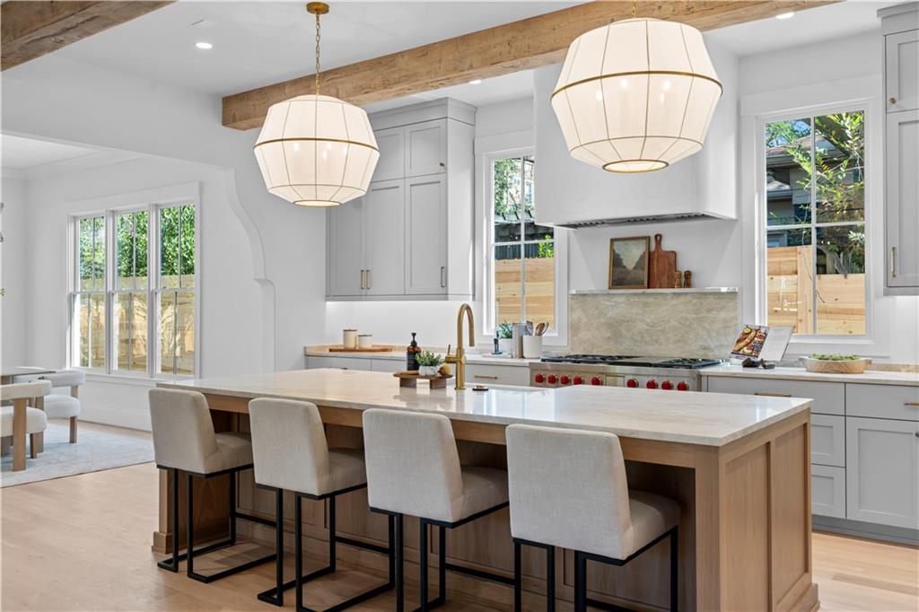 1140 Rosedale Drive Northeast Atlanta, GA 30306 - Photo 6 of 50 a kitchen with stainless steel appliances a table chairs and a chandelier