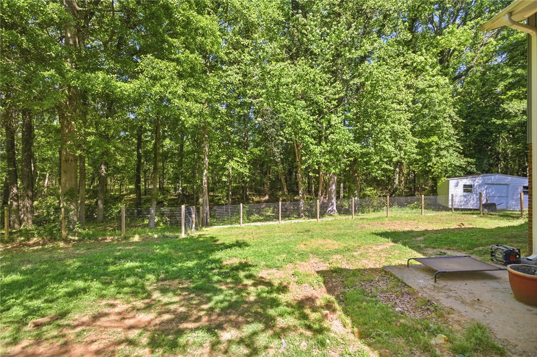 311 Cumberland Way Anderson, SC 29621 - Photo 38 of 44 A spacious backyard with mature trees provides ample green space and natural privacy.