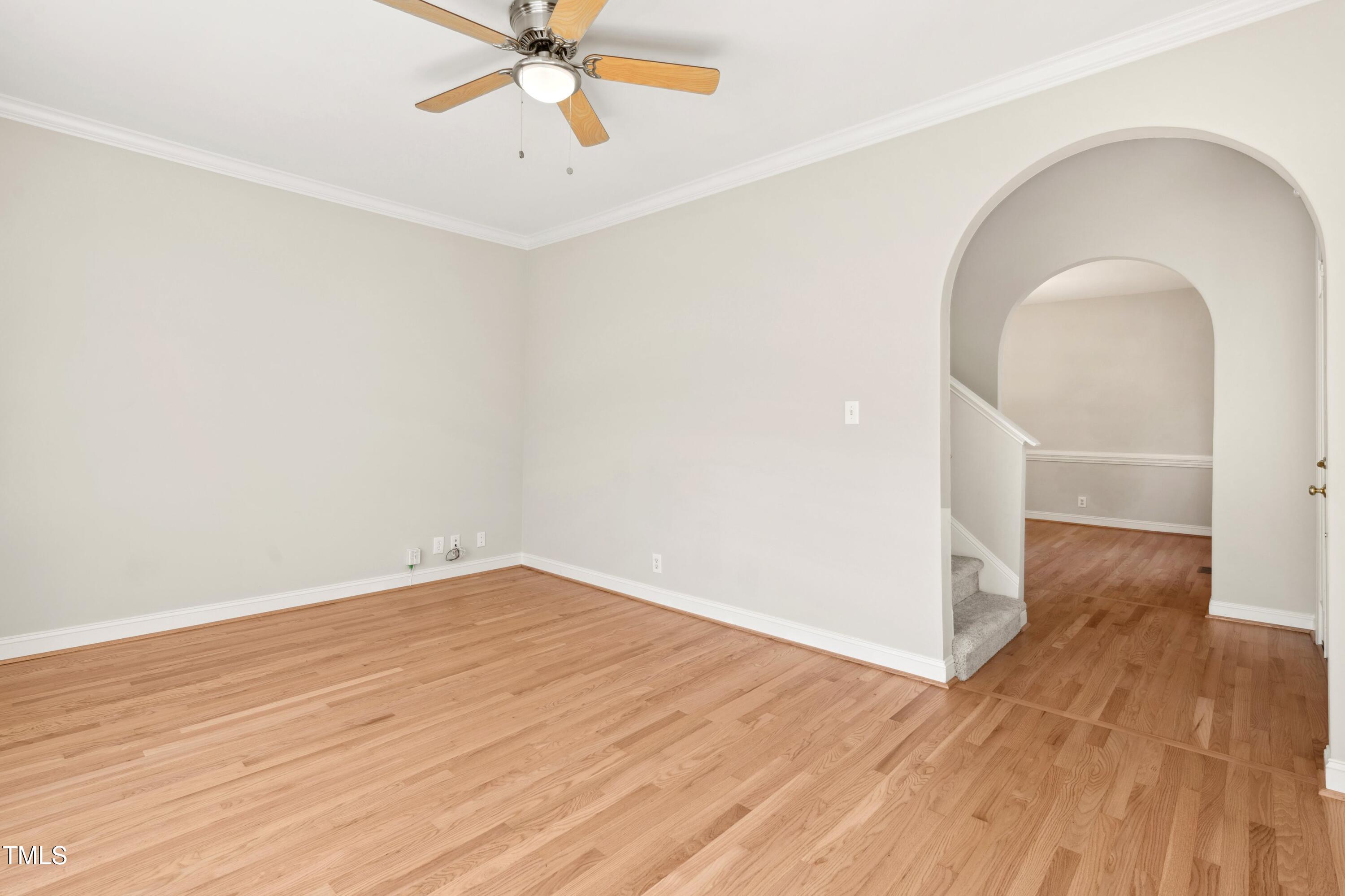 1909 Redding Lane Durham, NC 27712 - Photo 11 of 49 an empty room with wooden floor fan and windows