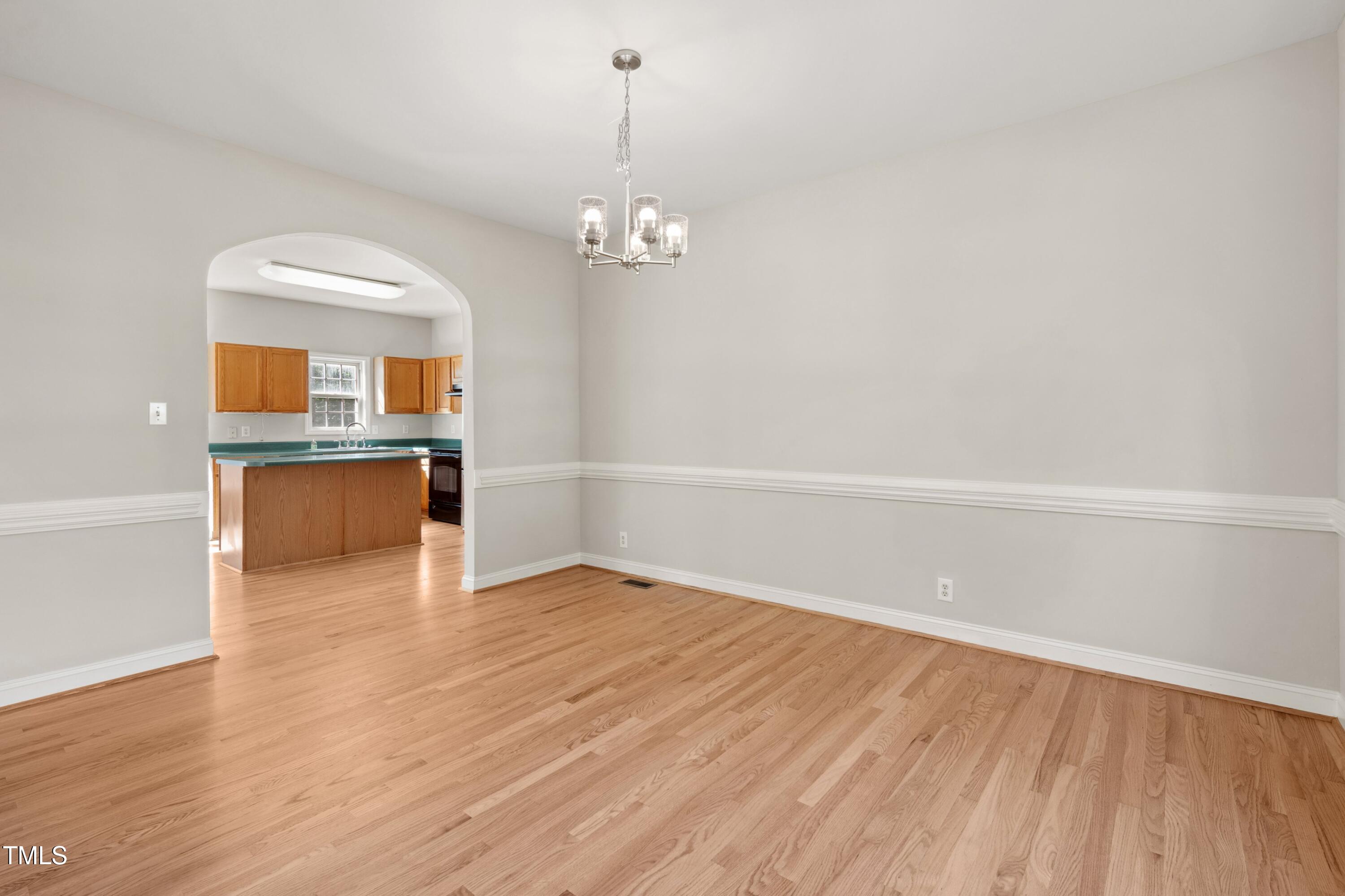 1909 Redding Lane Durham, NC 27712 - Photo 13 of 49 wooden floor in an empty room with a window