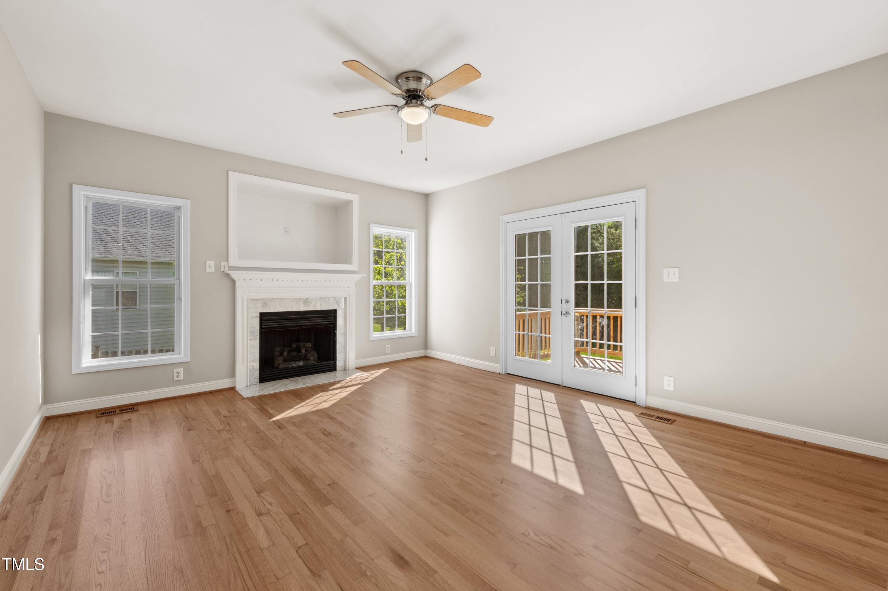 1909 Redding Lane Durham, NC 27712 - Photo 16 of 49 a view of empty room with wooden floor and fireplace