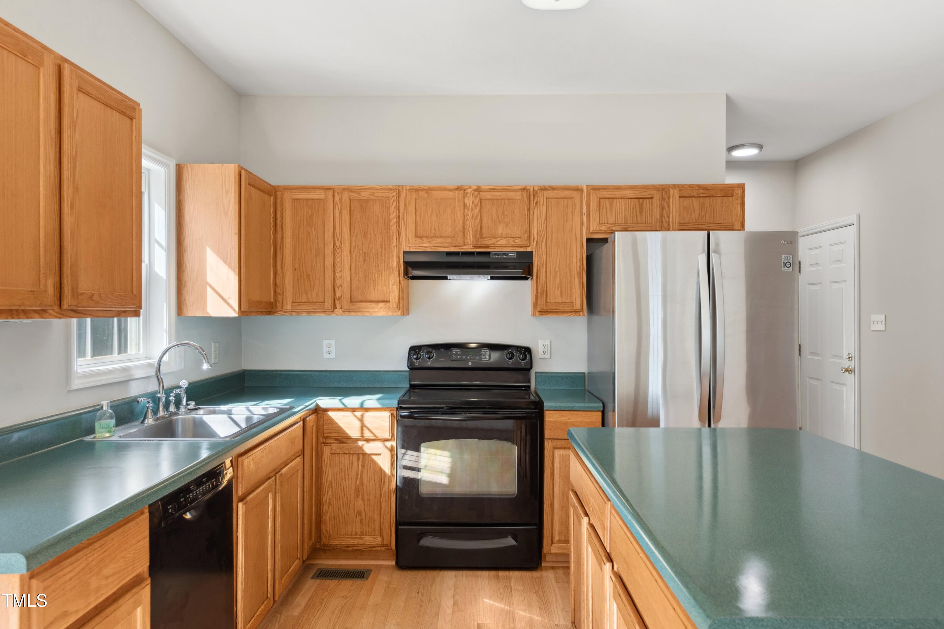 1909 Redding Lane Durham, NC 27712 - Photo 20 of 49 a kitchen with a refrigerator and a sink